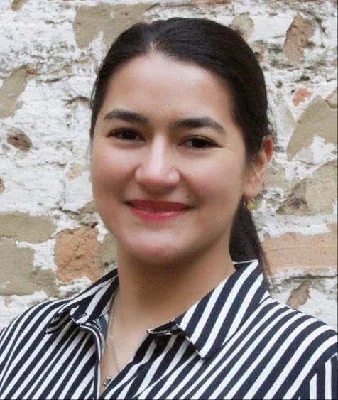 Woman in a black and white striped blouse.