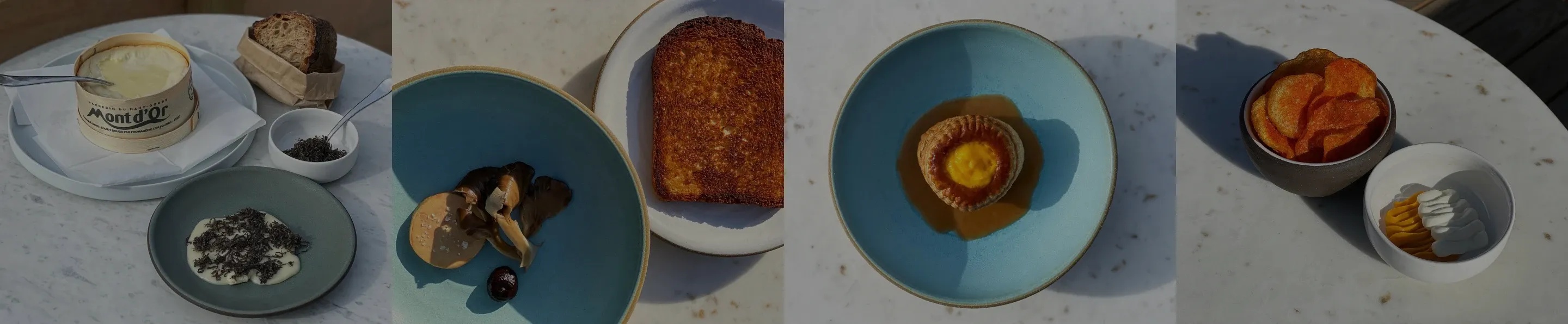 Various plates of food on a white table.