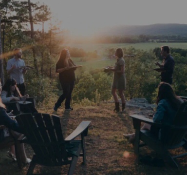 Image of people with a valley in the background.