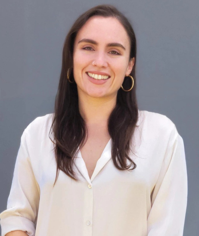 Woman in rust jacket with long hair Professional portrait of a smiling woman in a white shirt
