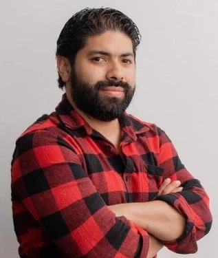 Man with a beard wearing a red and black plaid flannel shirt. Man with a beard wearing a red and black plaid flannel shirt.