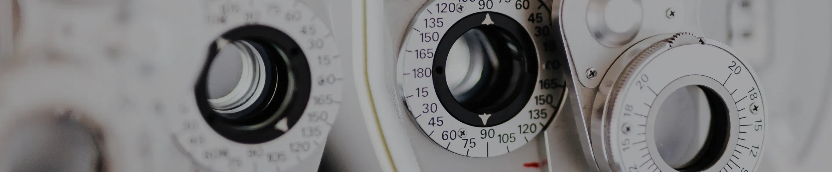 jjv-hero-desktop.webp Close up on a white Phoropter.