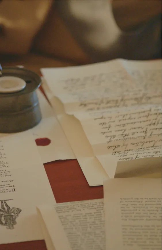 va250-cardbg-mobile.webp Old handwritten paper documents on desk.